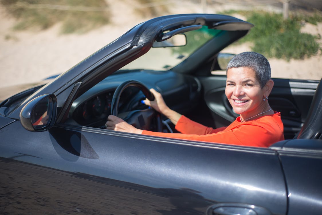 Woman happily driving a car 