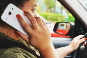 A woman driving while talking on a cell phone.